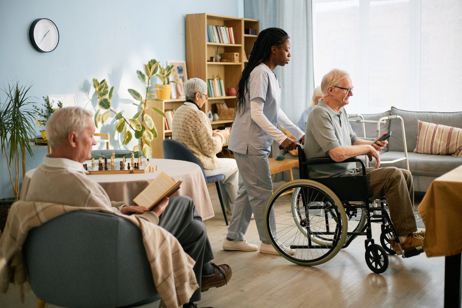 Caregiver assisting seniors in a comfortable residential living room